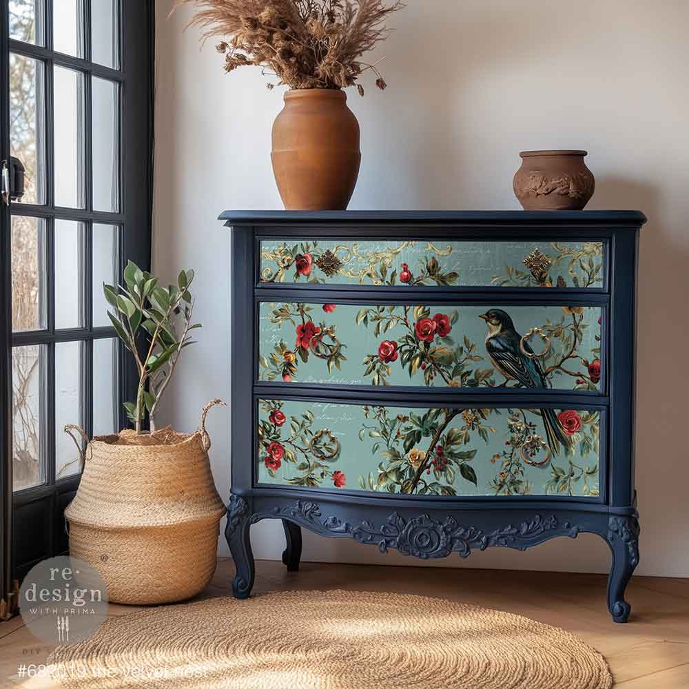 Decorative chest of drawers with floral and bird patterns in a room setting.