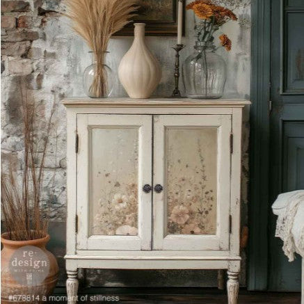 Vintage-style cabinet with floral-patterned doors against a rustic wall.