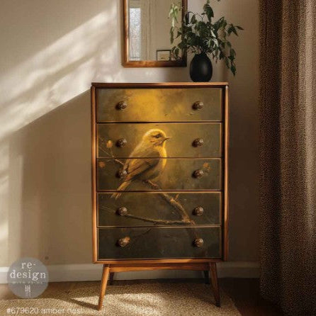 Wooden dresser with bird design in a room with a mirror and plant.