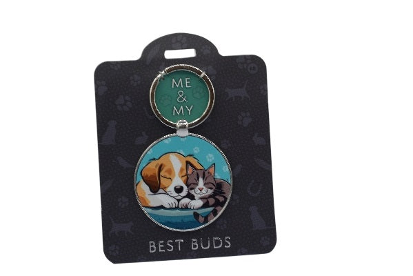 Keychain with dog and cat illustration on a black card with 'Me & My Best Buds' text