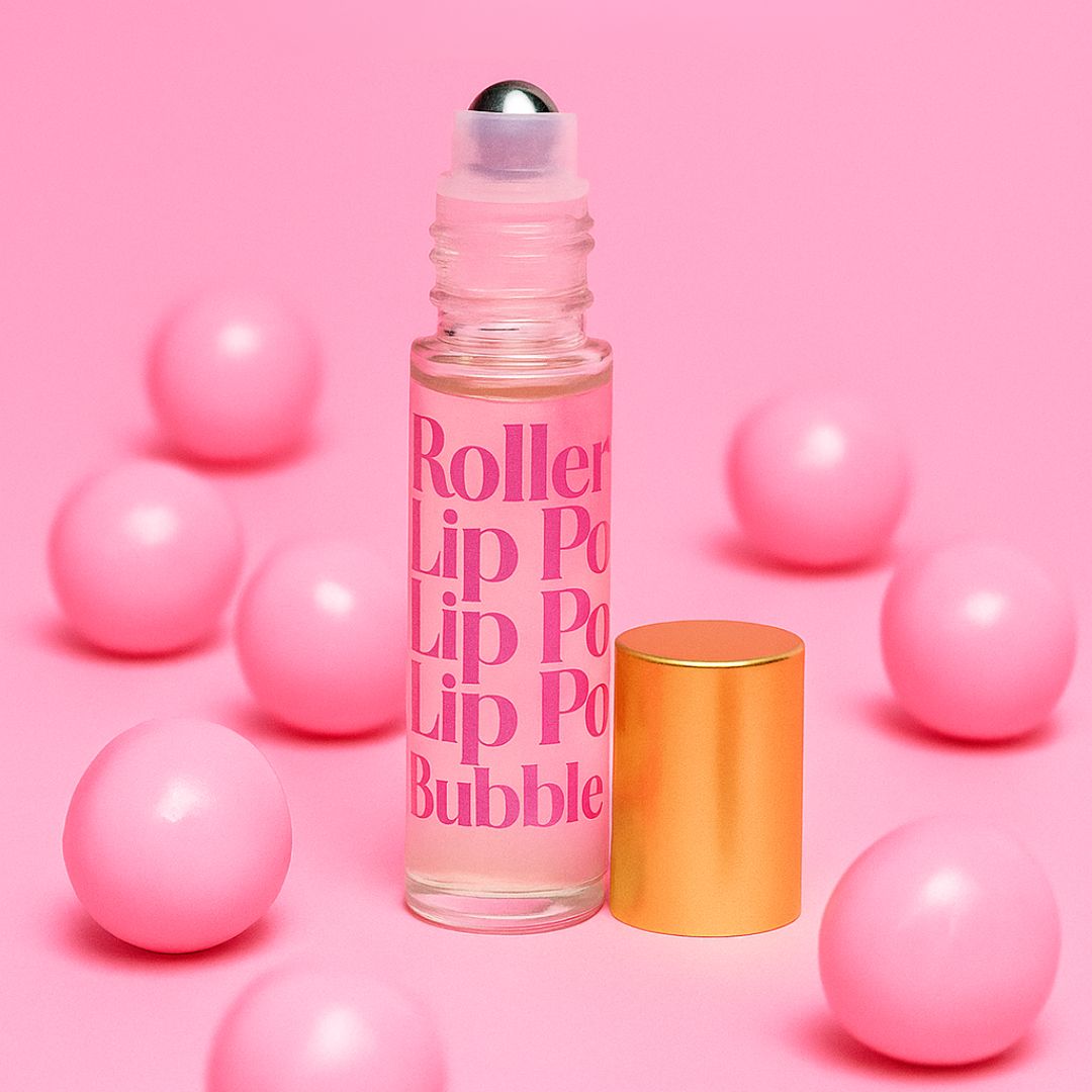 Rollerball lip product on a pink background with pink bubble gum balls