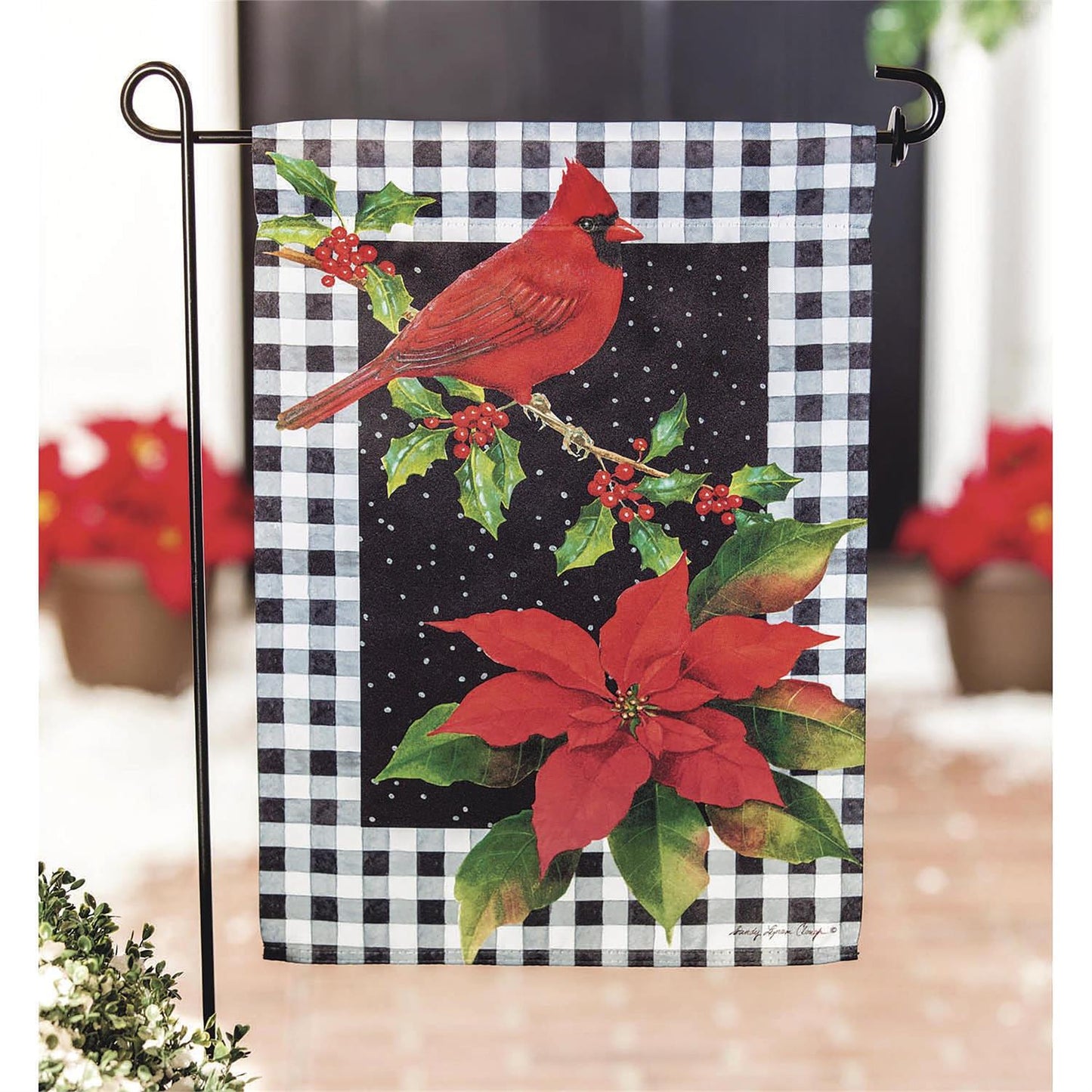 Christmas-themed garden flag with cardinal and poinsettia on a checkered background