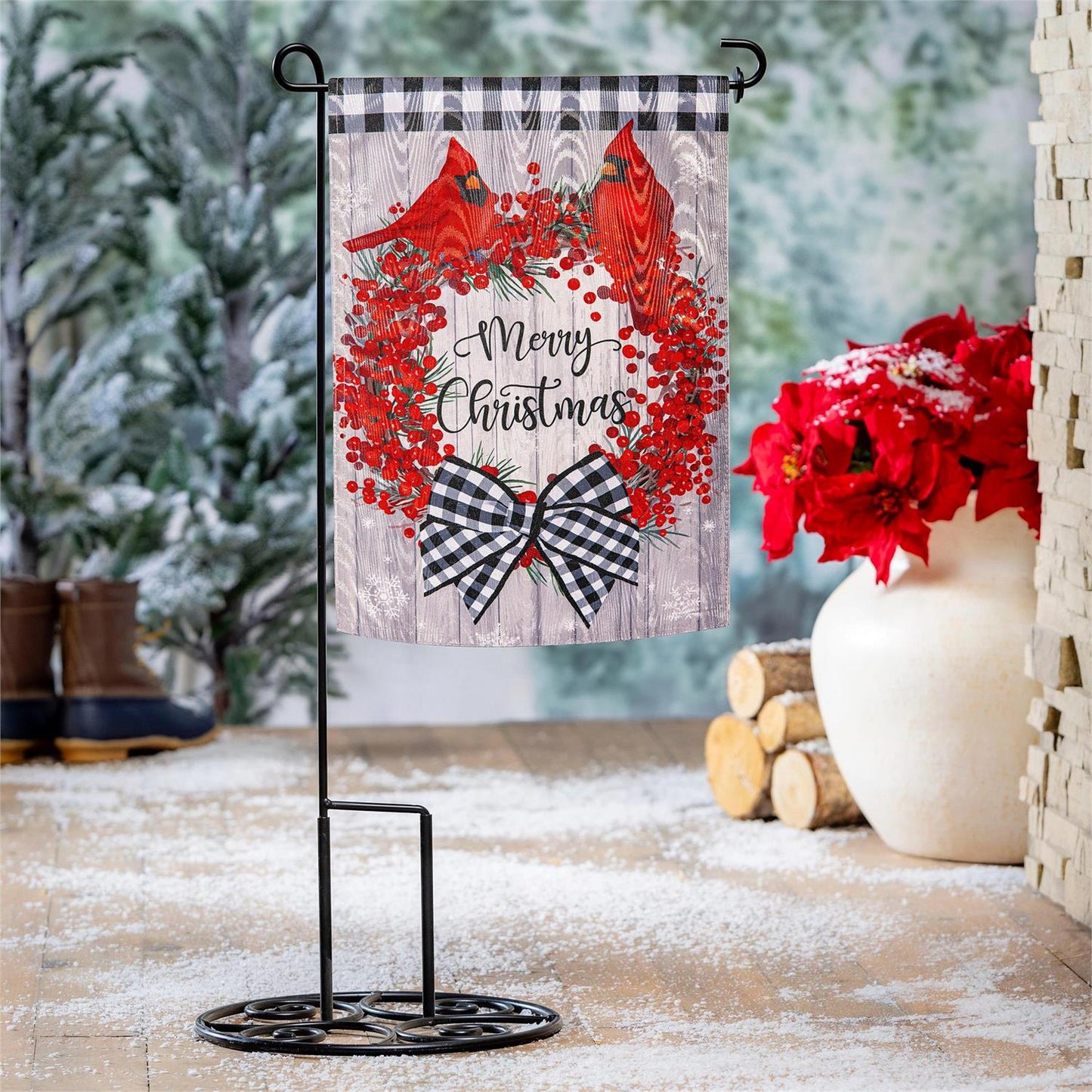 Christmas-themed decorative flag with cardinals and wreath on a stand, surrounded by festive decor.