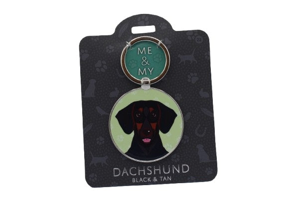 Keychain with dachshund design on a black card with brand name.
