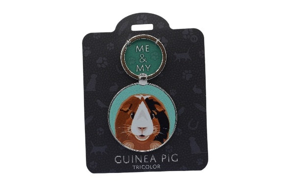 Keychain with guinea pig illustration on a black card with brand name.
