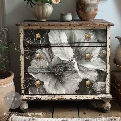Wooden cabinet with floral design and gold knobs in a home setting
