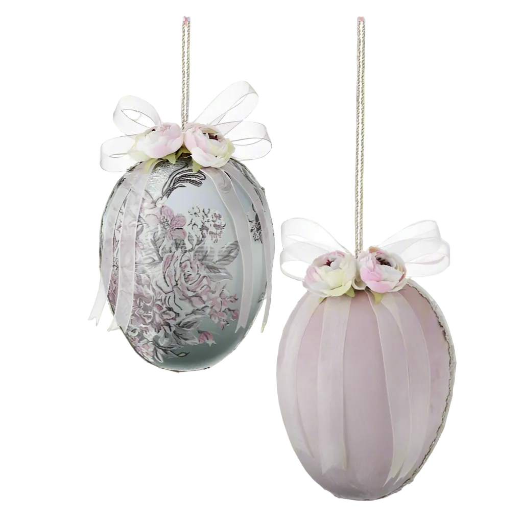 Two decorative Easter eggs with paisley pattern and velvet texture, featuring white accents and bows, displayed on a white background.