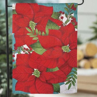poinsettia garden flag on a flag pole in a garden