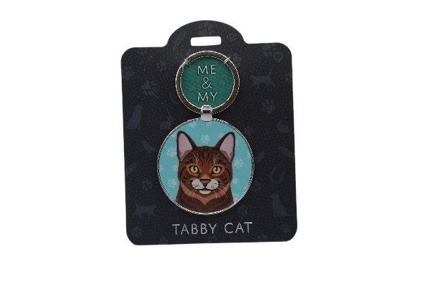 Keychain with tabby cat design on a black card with white paw prints