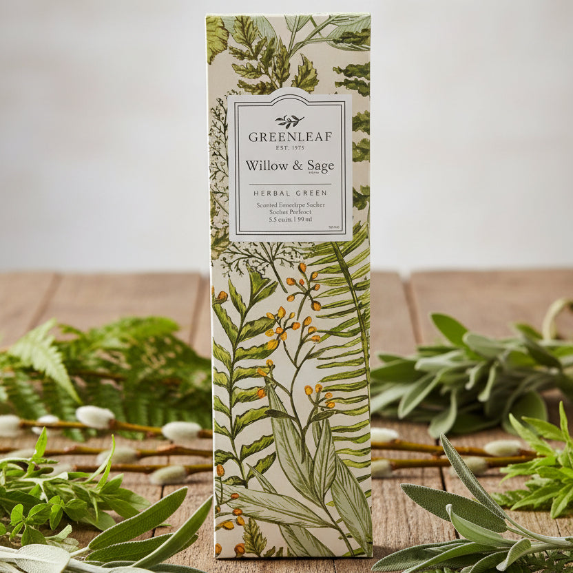 Greenleaf Willow & Sage slim sachet on a rustic table with herbal plants around it.