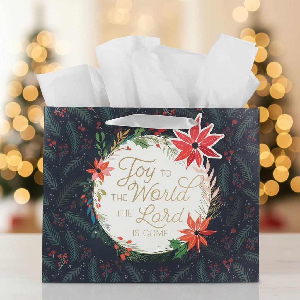 Christmas-themed gift bag with floral design and text 'Joy to the World the Lord is Come' against a blurred festive background.
