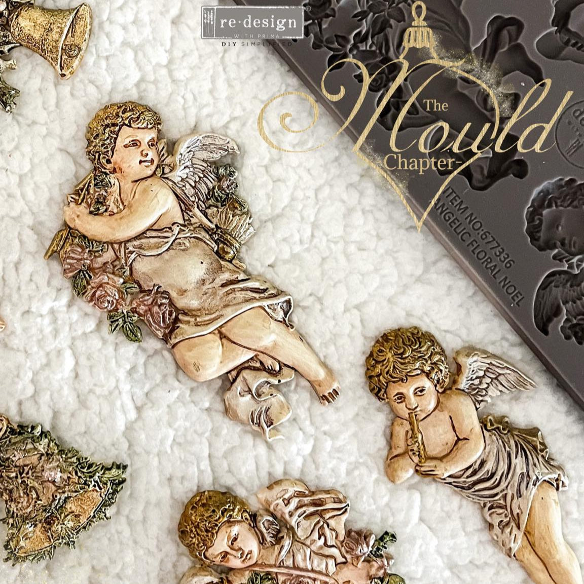 Decorative angel figurines with a 'Coming Soon' card for 'The Mould Chapter' by re:design on a textured surface.
