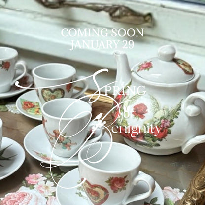 Tea set with Amour Affair transfers on a table, promotional text for 'Spring to Enigity' release.