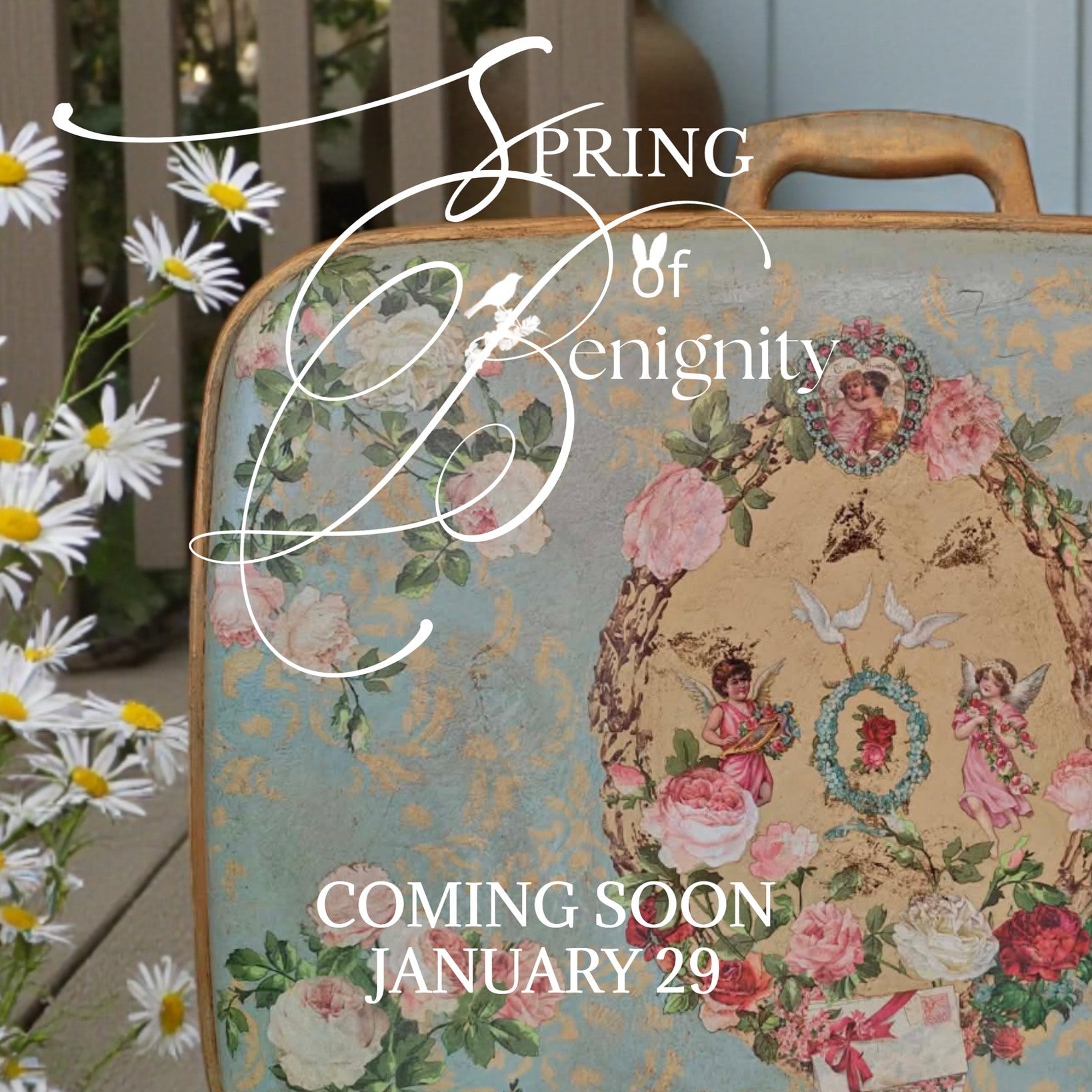 Vintage suitcase decorated with Amour Affair with 'Spring of Benignity' text and daisies on a wooden surface