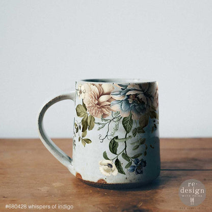Whispers of Indigo transfers on mug on a wooden surface with a light gray background