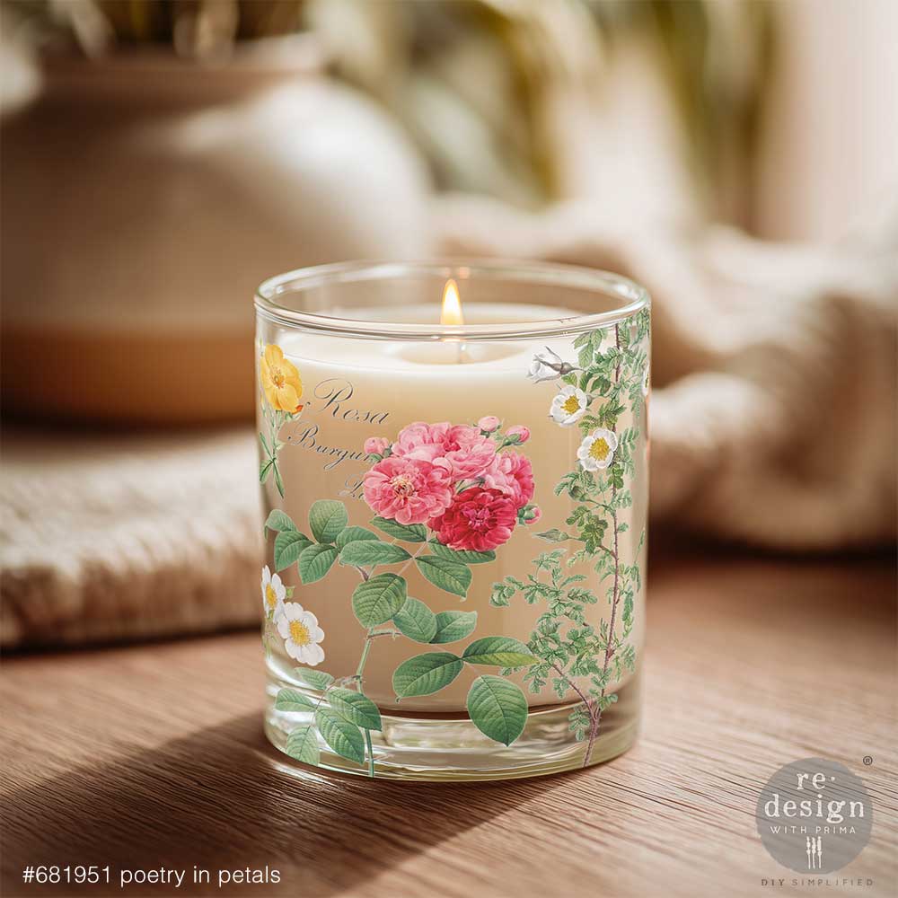 Candle in a glass holder decorated with Poetry in Petals H2O transfer on a wooden surface