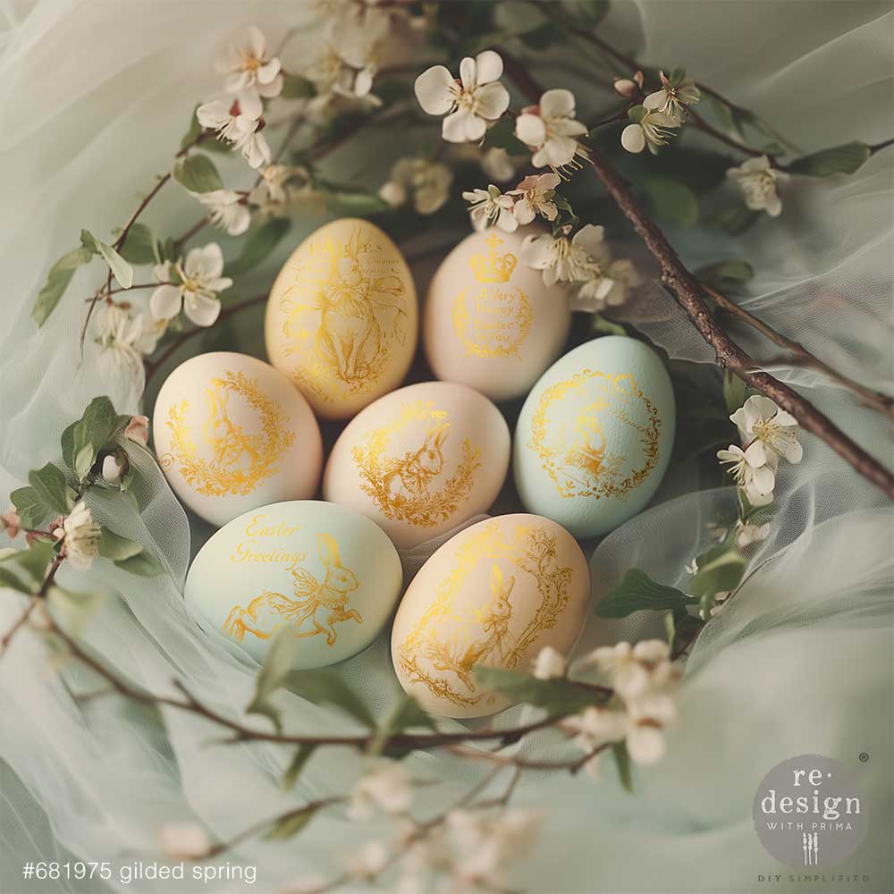 Easter eggs decorated with the Gilded Spring H2O transfers on a green leafy background.