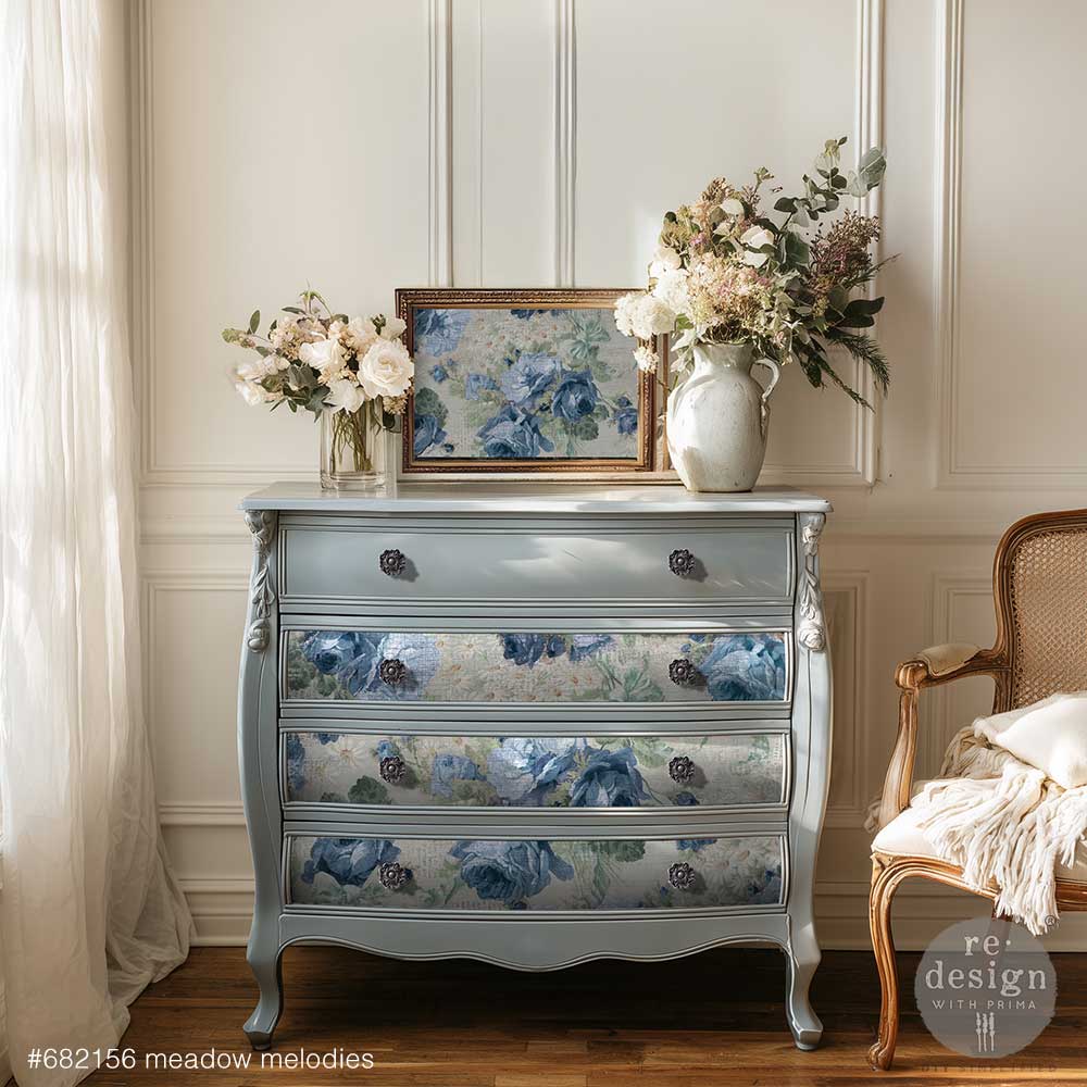 Meadow Melodies decoupage paper is featured on a light blue dresser in a room with flowers and a chair.