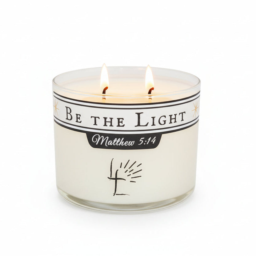 Candle with 'Be the Light Matthew 5L:14' message on a white background.