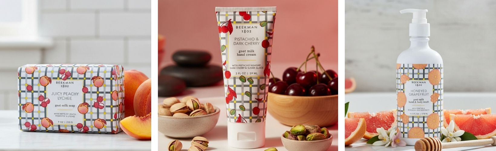 Collection of Beekman 1802 skin care products with fruits and nuts on a kitchen counter.