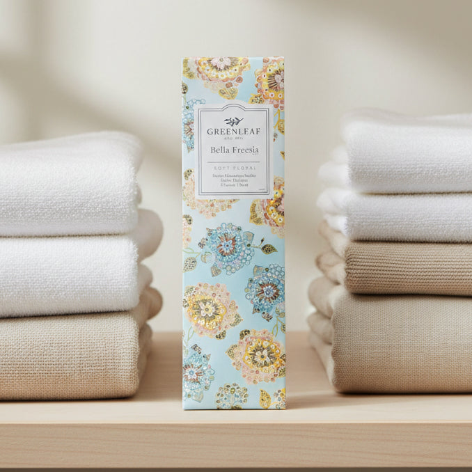 Greenleaf Bella Freesia slim sachet on a closet shelf with towels.