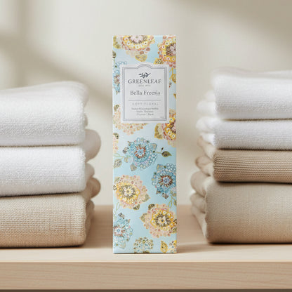 Greenleaf Bella Freesia slim sachet on a closet shelf with towels.