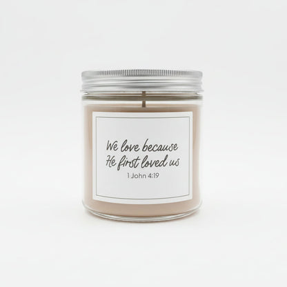 Sweet Grace jar candle with white label and "We love because He first loved us" in black on a white background.