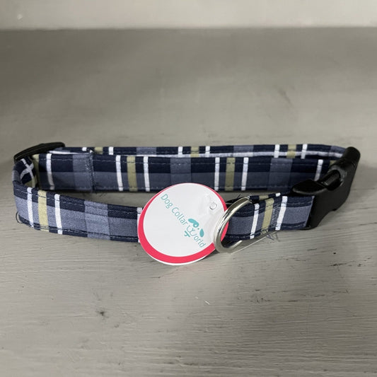 Plaid dog collar with a tag on a gray surface