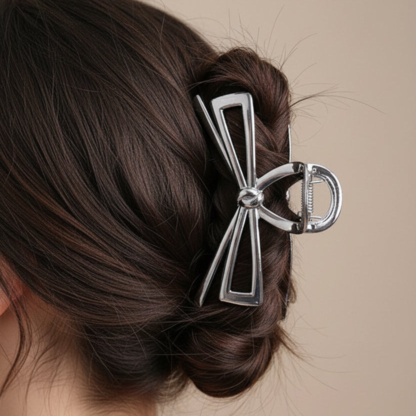 Silver bow-shaped hair clip in a woman's hair