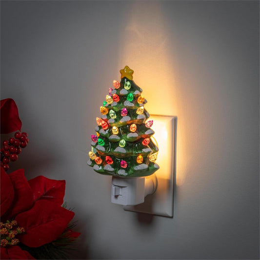 Decorative night light shaped like a Christmas tree with colorful lights on a wall.