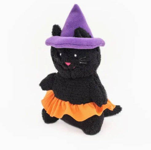 Black cat plush toy with a purple witch hat and orange skirt on a white background
