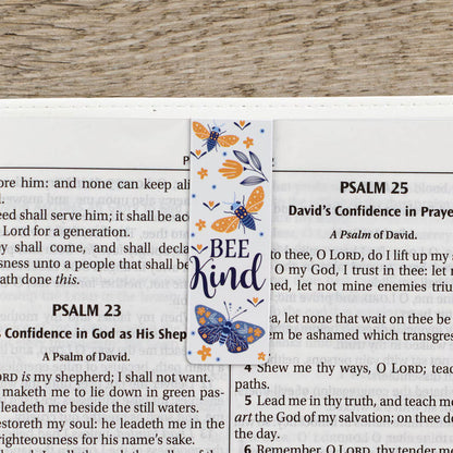 Bookmark with butterfly design and 'Bee Kind' text on a Bible