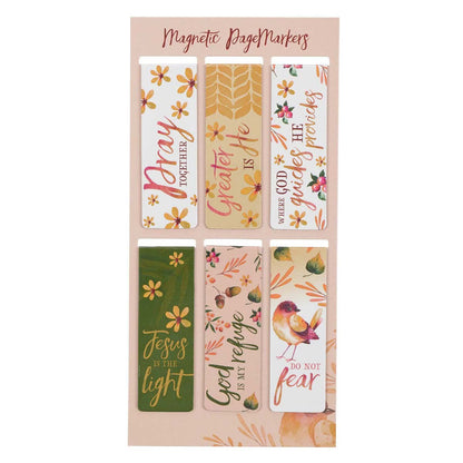 Set of magnetic page markers with various designs and text on a pink card.