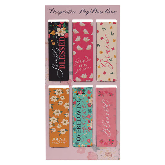 Set of colorful magnetic page markers with floral and motivational designs on a pink background.