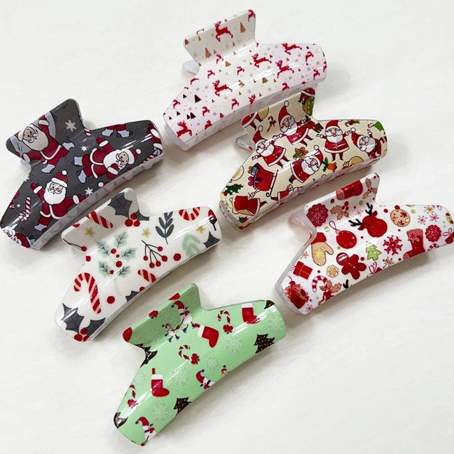Set of Christmas-themed hair clips on a white background