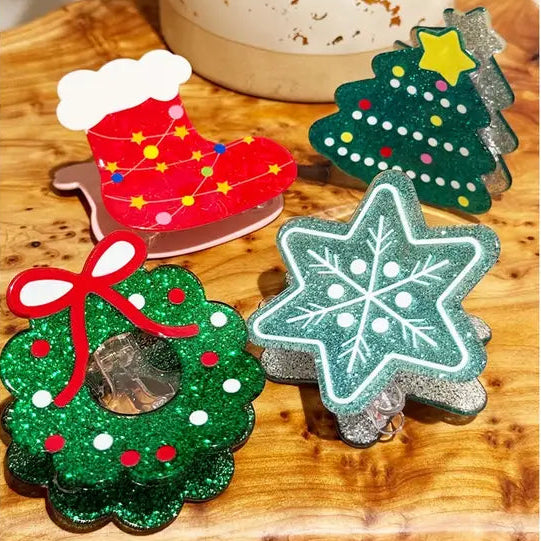 Set of Christmas-themed coasters on a wooden surface.