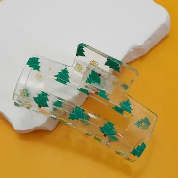 Hair claw with green tree pattern on a yellow background