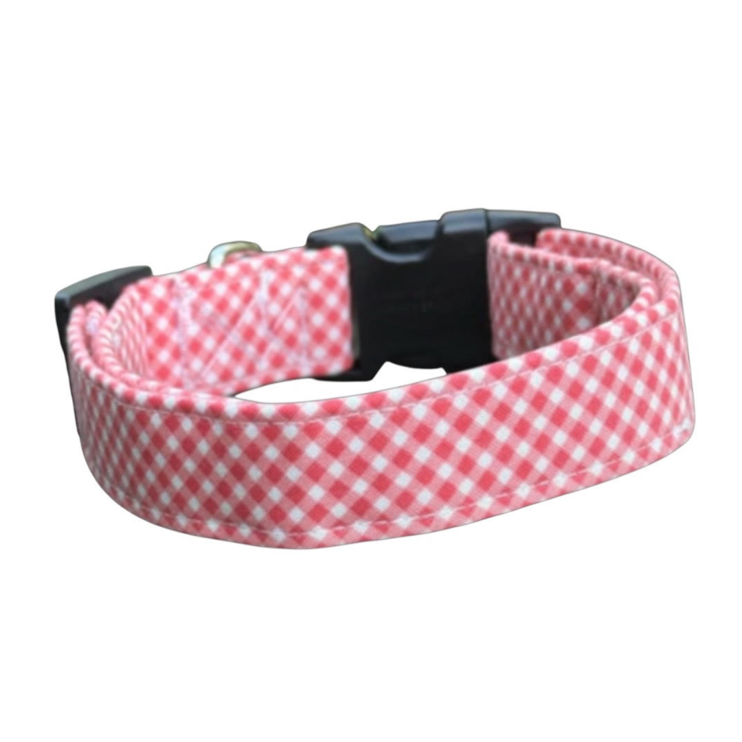 coral gingham dog collar with a black buckle on a white background