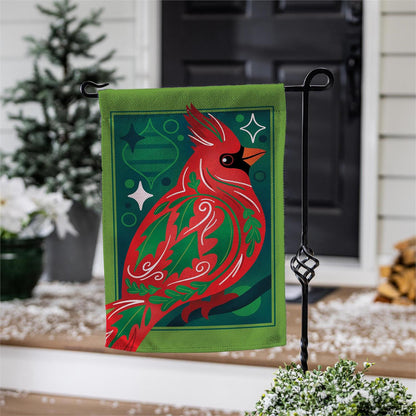 Decorative garden flag with a red cardinal design on a stand outdoors.