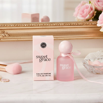 A bottle of Sweet Grace Eau de Parfum next to it's box on a woman' vanity