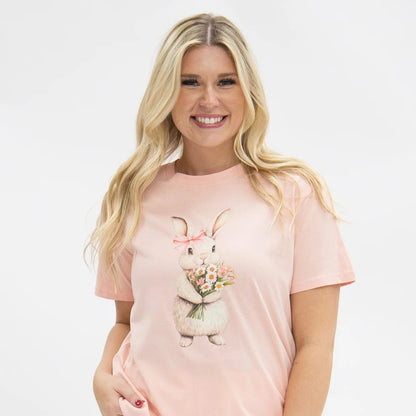 Woman wearing a pink t-shirt with a bunny graphic design on a white background