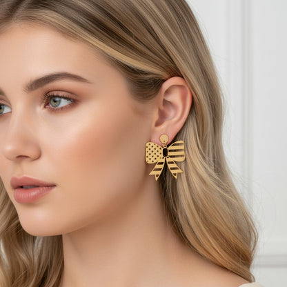 Fourth of July Star Stripe Bow Matte Gold Earrings on a woman