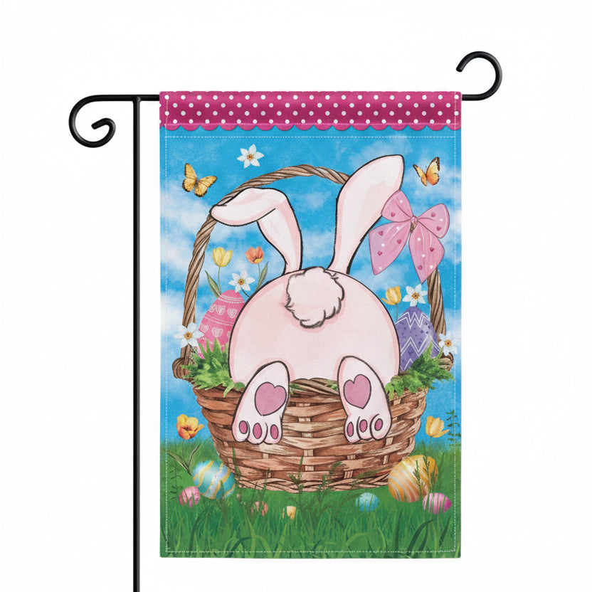 Evergreen Basket Bunny garden flag with bunny ears, eggs, and a basket on a blue sky background.