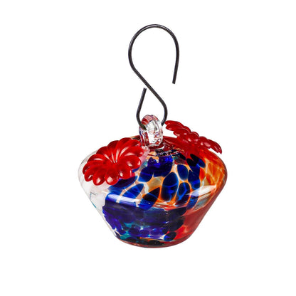 Colorful glass hummingbird feeder with a hook on a white background