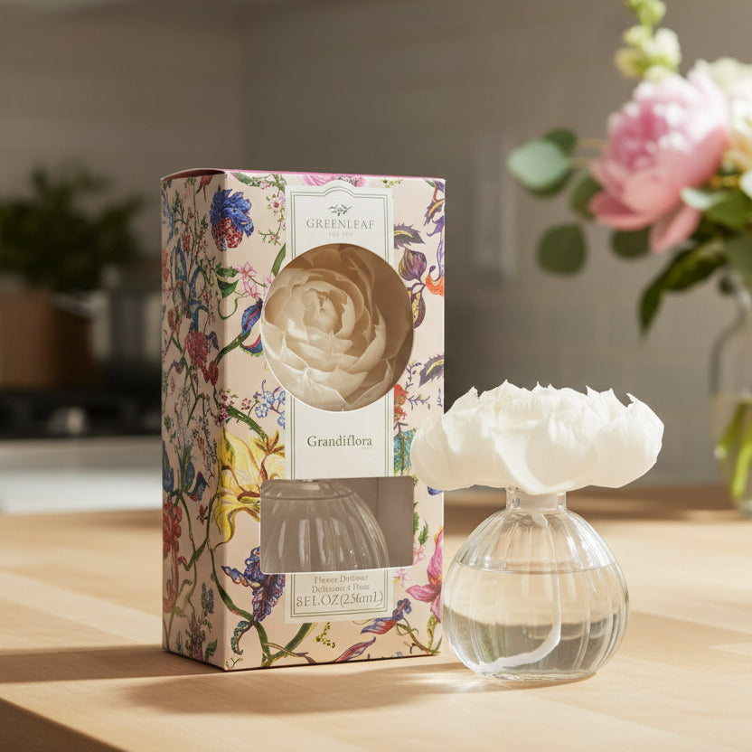 Greenleaf Grandiflora flower diffuser on a kitchen counter with flowers in the background.