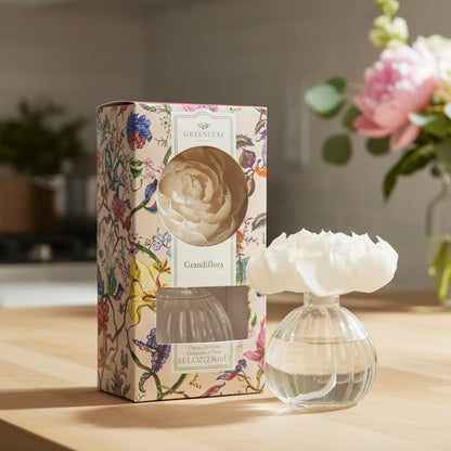 Greenleaf Grandiflora flower diffuser on a kitchen counter with flowers in the background.