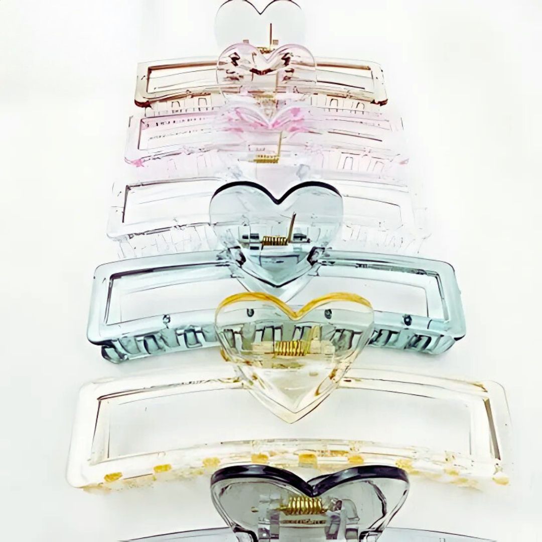 Stack of heart-shaped hair clips on a white background
