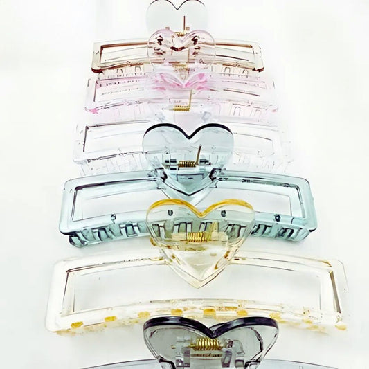 Stack of heart-shaped hair clips on a white background