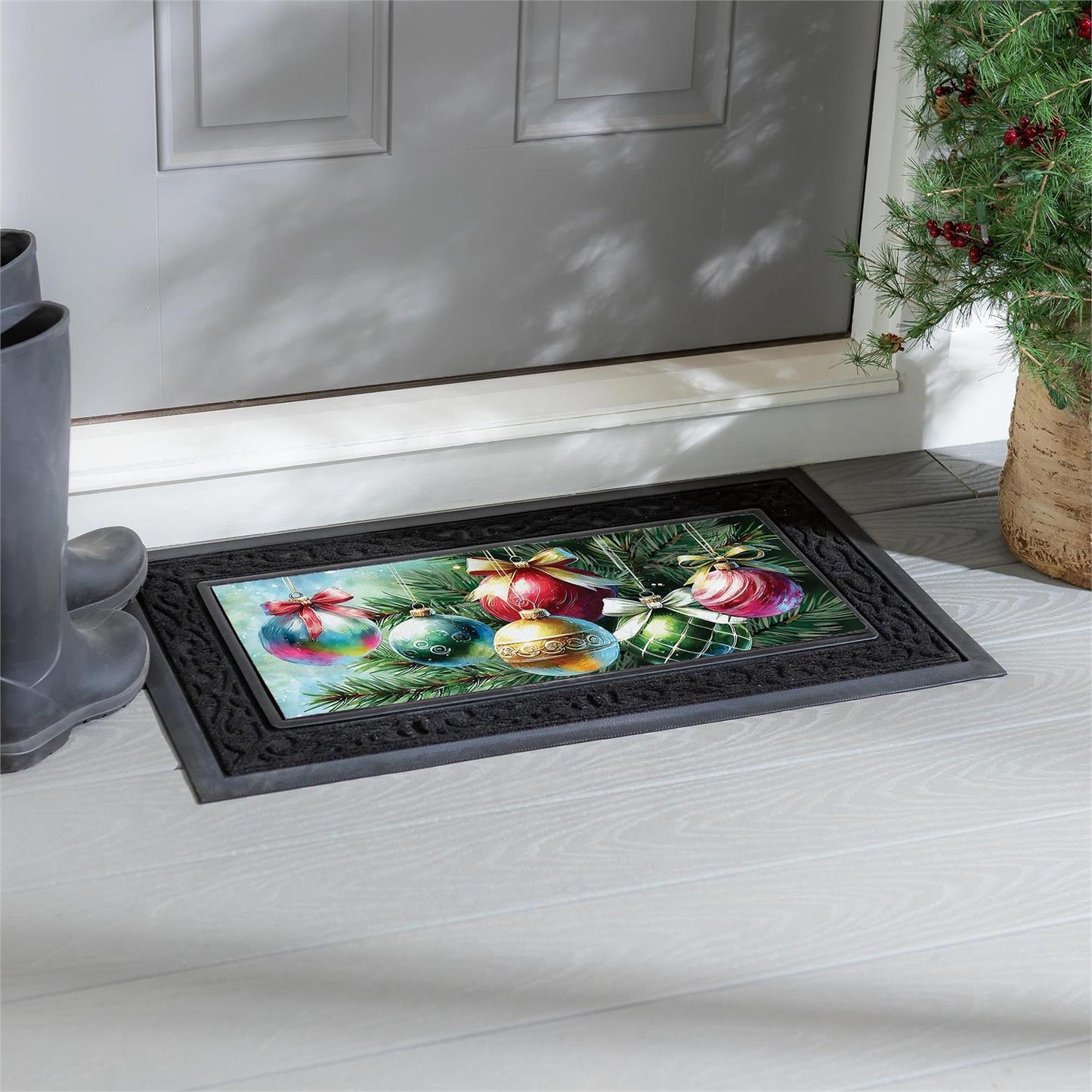 Decorative doormat with Christmas ornaments on a white floor in front of a door.