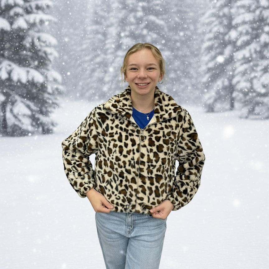 Person wearing a leopard print jacket in a snowy landscape